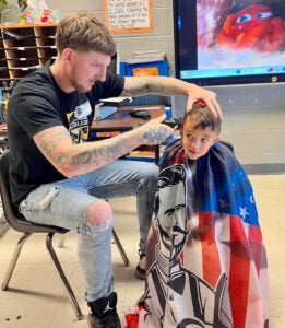 Dustin Taulbee gives a haircut to a customer at Unbridled Barber Shop. (Photo submitted)