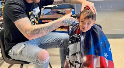 Dustin Taulbee gives a haircut to a customer at Unbridled Barber Shop. (Photo submitted)