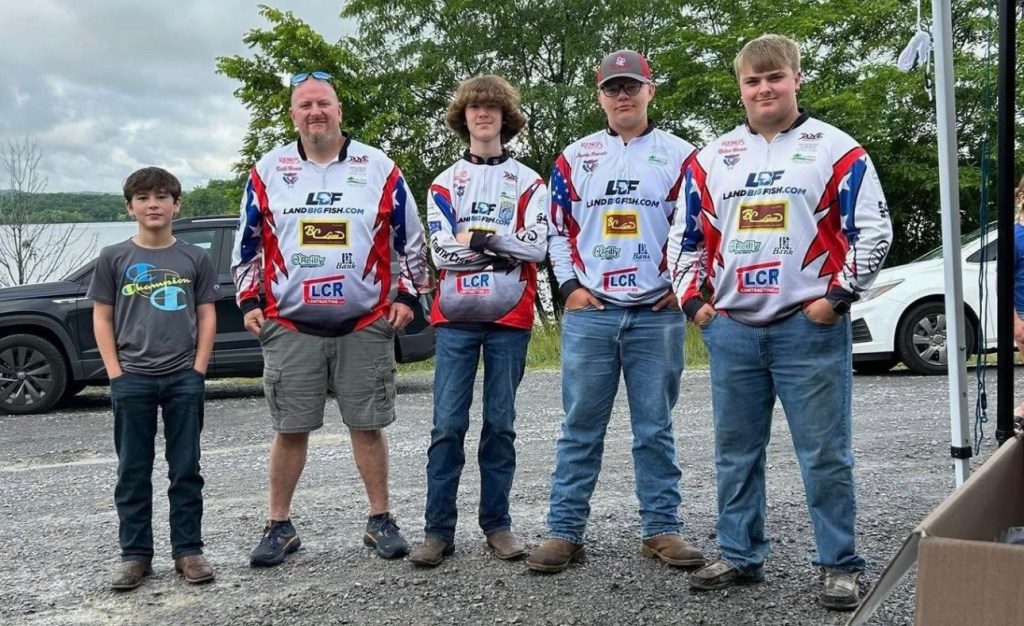 Members of the Lincoln County Bass Fishing Team recently volunteered at the Cedar Creek Fishing Derby as part of their ongoing community outreach efforts. Pictured from left to right are Ryder White, Coach Keith Hamm, Storm Douglas, William Gimpel, and Nolan Hamm. The team will help lead the upcoming Coaches Clinic and Boater Safety Course on August 23. (Photo submitted)